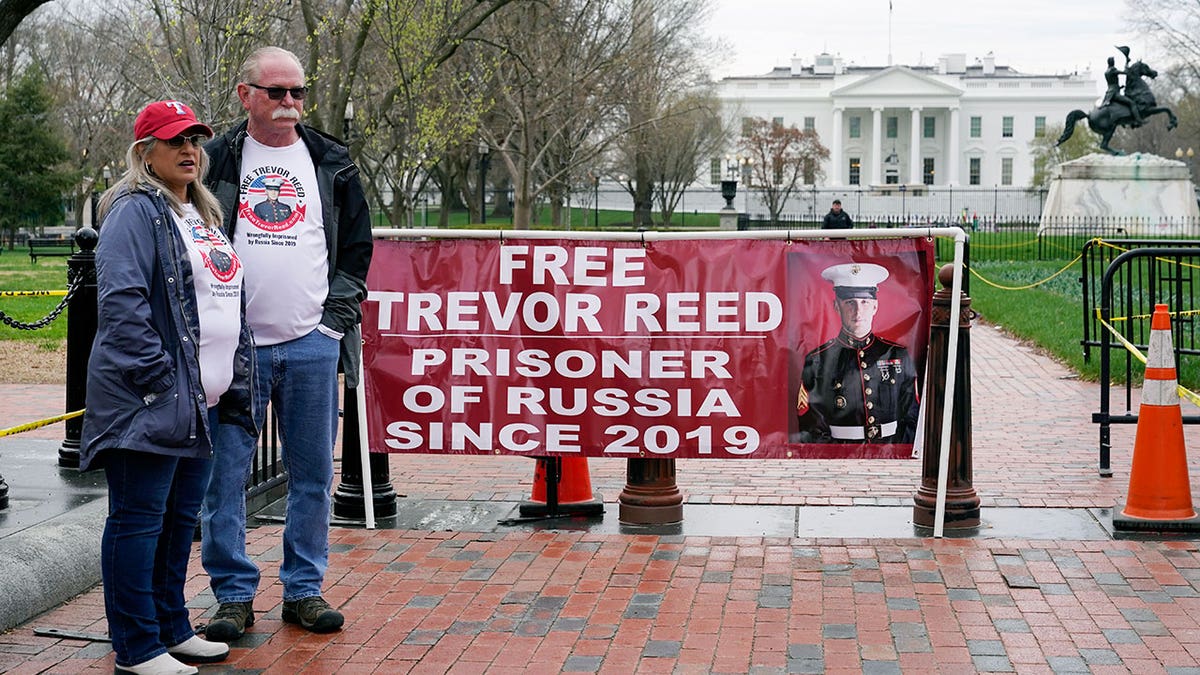Joey and Paula Reed, parents of U.S. Marine Corps veteran and Russian prisoner Trevor Reed, stand in Lafayette Park near the White House, Wednesday, March 30, 2022, in Washington. 