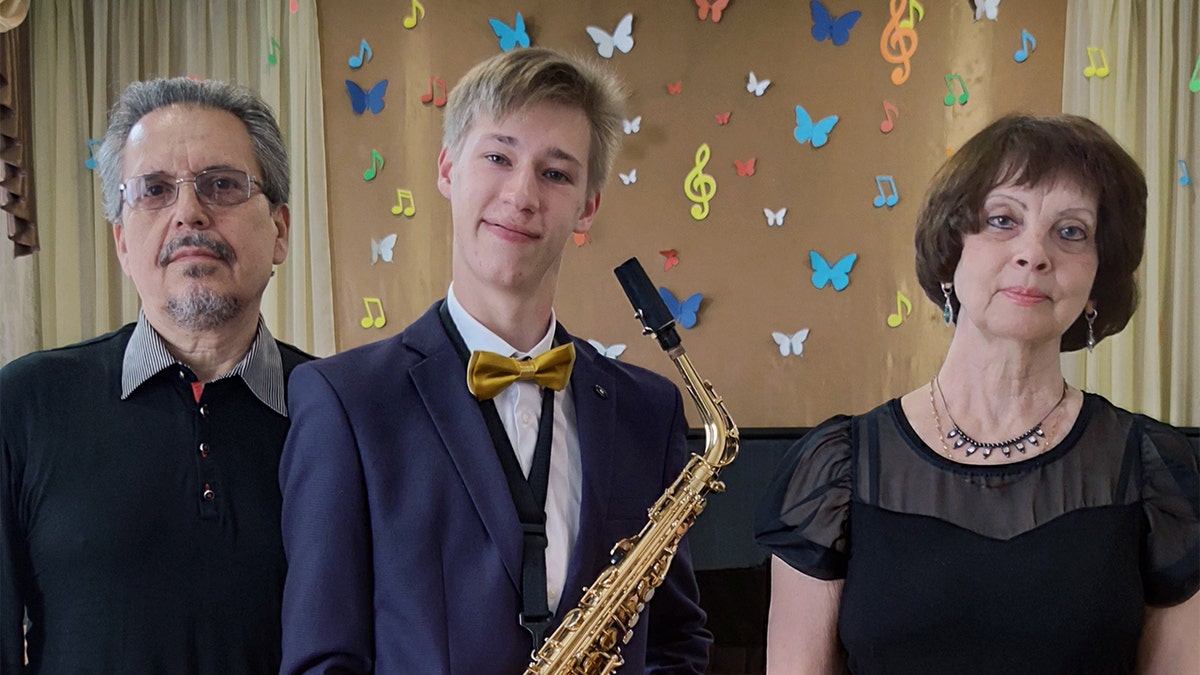 Matthew Frantsuzhan, a choir member, saxophone player and piano player, is shown here with two of his music teachers. He studied music in Ukraine for eight years before arriving in the U.S. as an exchange student.