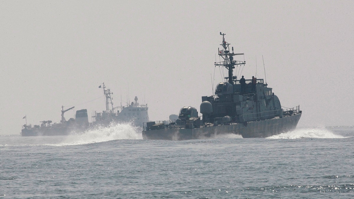 South Korean navy patrol ships search for survivors from a sunken South Korean navy ship near South Korea's Baekryeong island, March 29, 2010. 