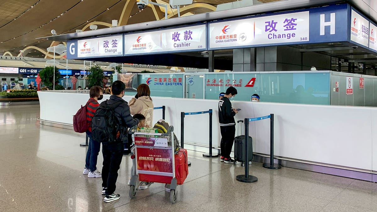 Passengers check in at the China Eastern Airlines rebook counter following a state media report that all 737-800s in China Eastern's fleet were ordered grounded,