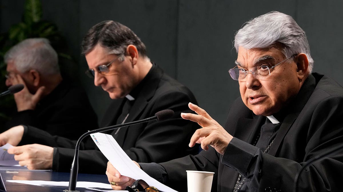 Cardinal Marcello Semeraro, right, talks during the presentation of the long-awaited reform program of the Holy See bureaucracy, during a press conference at the Vatican, Monday March 21, 2022. Pope Francis released "Praedicate Evanglium," or "Proclaiming the Gospel," a 54-page text that replaces the founding constitution "Pastor Bonus" penned by St. John Paul II in 1988. At center is Mons. Marco Mellino.