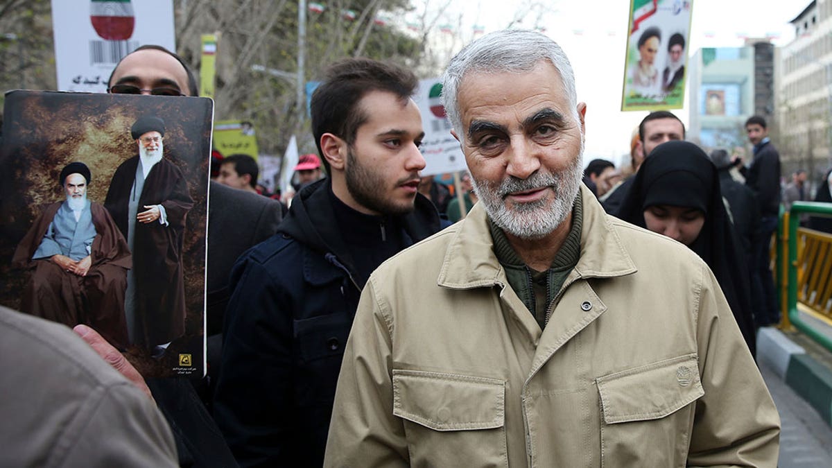 Soleimani walks with a crowd