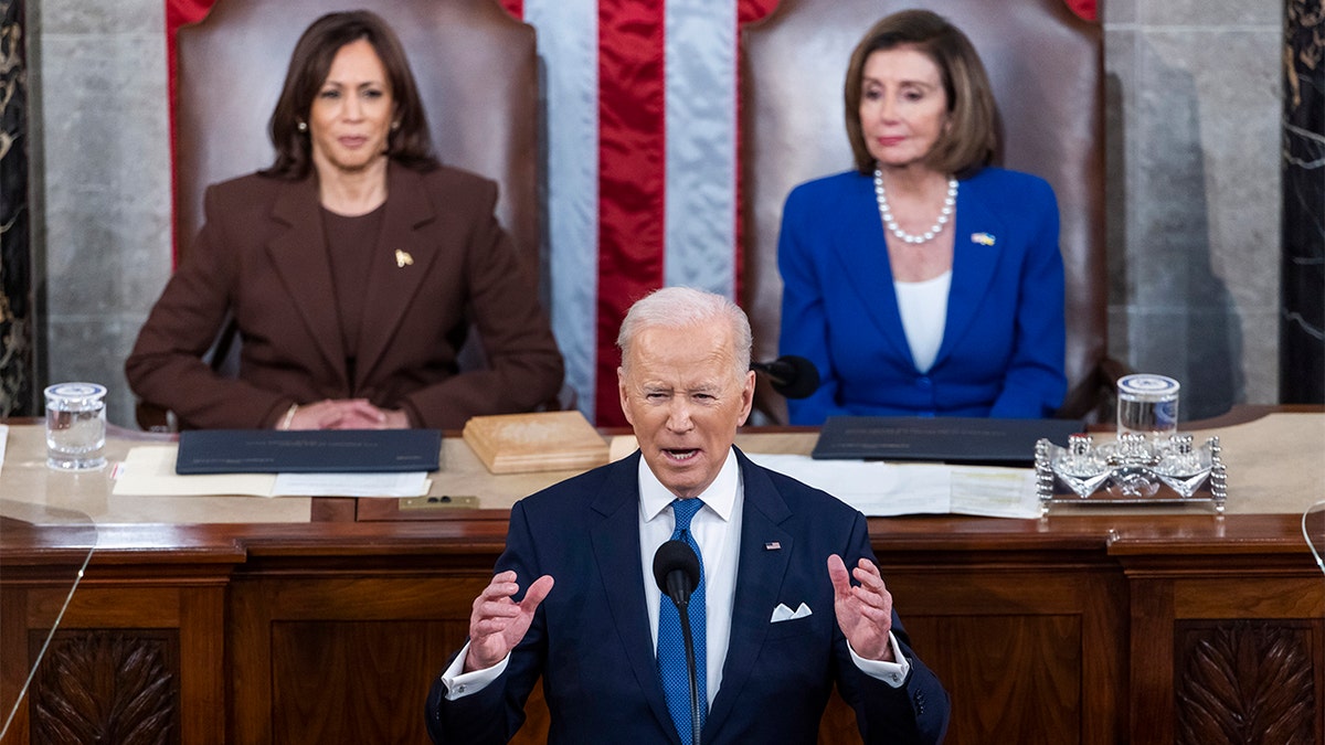 President Joe Biden delivers his first State of the Union address to a joint session of Congress at the Capitol, Tuesday, March 1, 2022, in Washington as Vice President Kamala Harris and House Speaker Nancy Pelosi of California, look on.