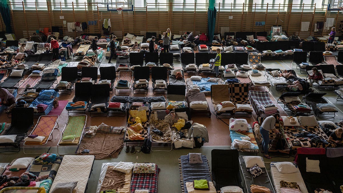 People who fled the war in Ukraine rest inside an indoor sports stadium being used as a refugee center, in the village of Medyka, a border crossing between Poland and Ukraine, on March 15, 2022. 