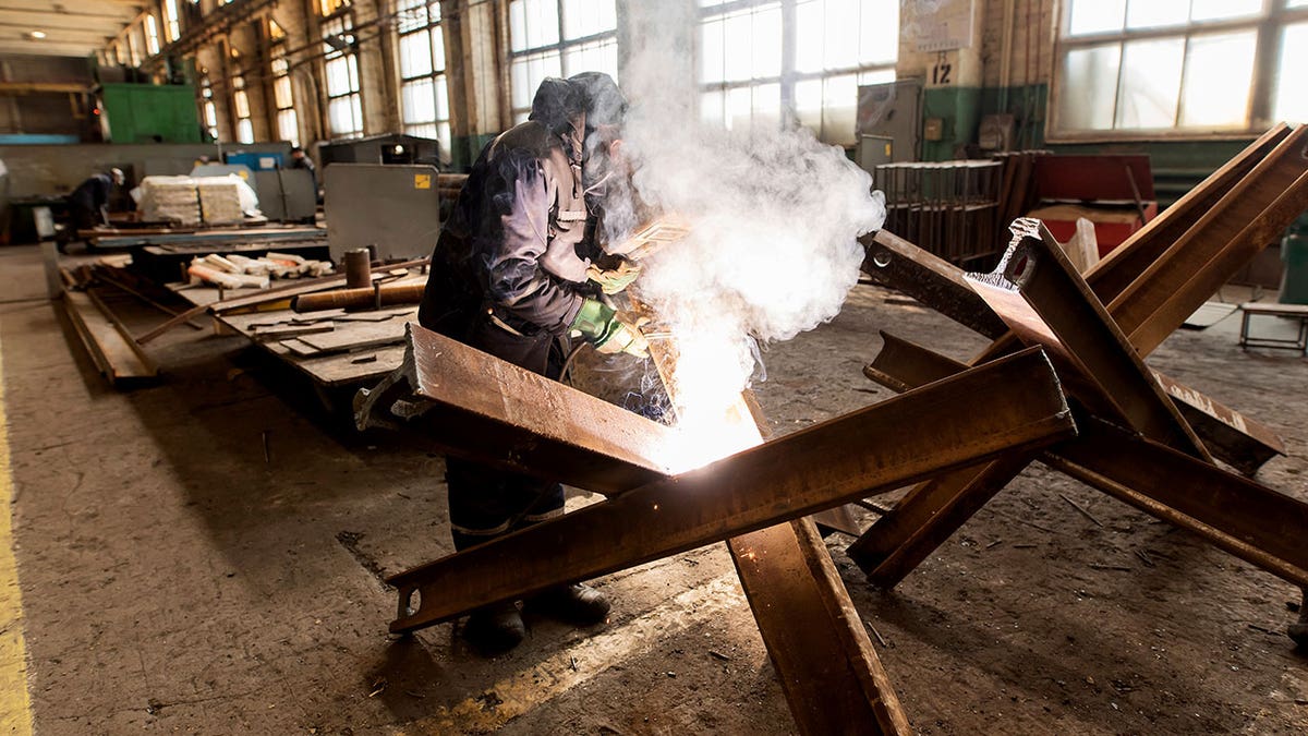 A worker welds metal inside the Interpipe Steel plant in Dnipro, Ukraine, Thursday, March 10, 2022. 