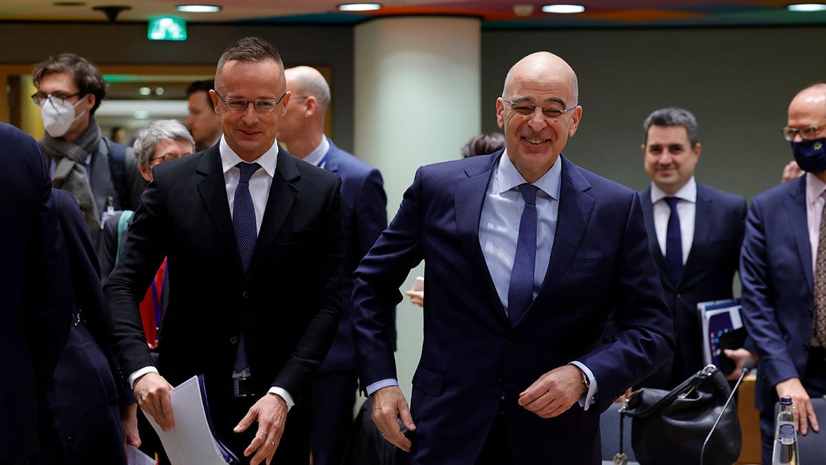 Hungarian Foreign Minister Péter Szijjártó, left, speaks with Greek Foreign Minister Nikos Dendias during a meeting of the EU foreign ministers at the Europa building in Brussels, Monday, March 21, 2022. 