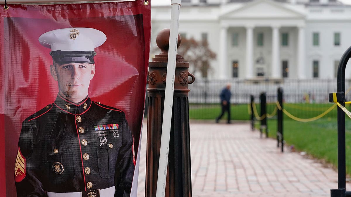 A poster photo of U.S. Marine Corps veteran and Russian prisoner Trevor Reed stands in Lafayette Park near the White House, Wednesday, March 30, 2022, in Washington. 
