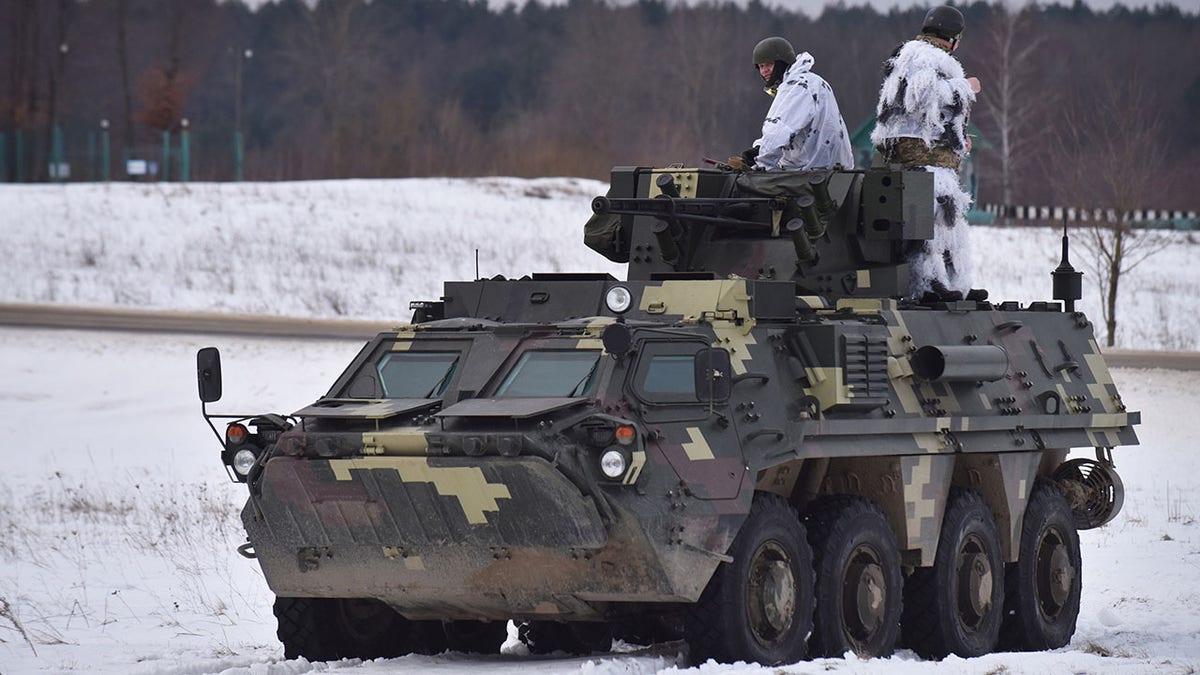 Ukrainian soldiers ride on top of the BTR-4 "Bucephalus" during the weapons training exercise on Feb. 4, 2022, in Lviv, Ukraine.