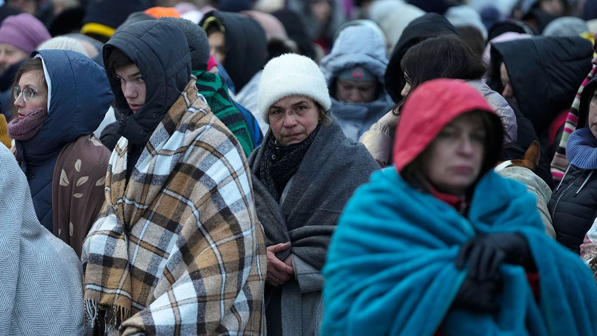 Ukraine refugees wait in line at the border of Poland.