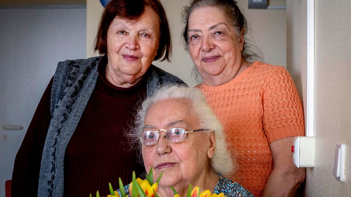 Ukrainian Holocaust survivors Tatyana Zhuravliova, right, Larisa Dzuenko, left, and Galina Ulyanova pose for a photo during an AP interview in an old people's home in Frankfurt, Germany, Sunday, March 27, 2022. 