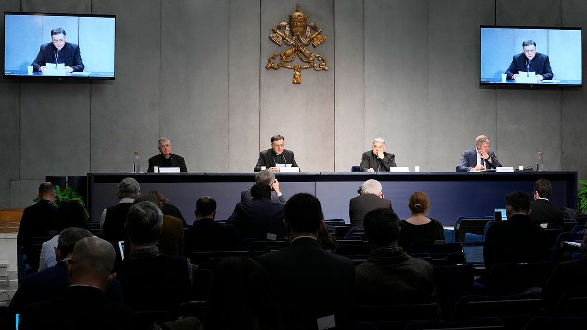 From left, Professor Gianfranco Ghirlanda, Mons. Marco Mellino, Cardinal Marcello Semeraro, and Vatican's spokesman Matteo Bruni, attend the presentation of the long-awaited reform program of the Holy See bureaucracy, during a press conference at the Vatican, Monday March 21, 2022. Pope Francis released "Praedicate Evanglium," or "Proclaiming the Gospel," a 54-page text that replaces the founding constitution "Pastor Bonus" penned by St. John Paul II in 1988. At center is Mons. Marco Mellino.