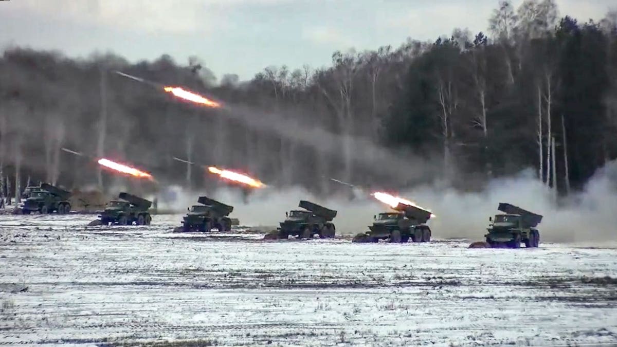 Russia army firing rockets, which fly with trails of fire behind them