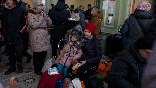 Ukrainian refugees wait at Przemysl train station.