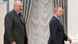 Russian President Vladimir Putin, right, and Belarusian President Alexander Lukashenko leave a joint news conference following their talks in the Kremlin in Moscow, Russia, Friday, Feb. 18, 2022. (Sergei Guneyev, Sputnik, Kremlin Pool Photo via AP)