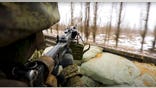 Russian Defense Ministry Press Service photo shows soldiers pointing gun from military truck in Ukraine
