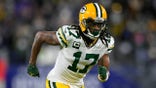 FILE - Green Bay Packers wide receiver Davante Adams runs on the field in the first half of an NFL football game against the Baltimore Ravens, Sunday, Dec. 19, 2021, in Baltimore. The Packers have several moves to make this month to not only get under the salary cap but also have enough room for a new contract to keep Adams, the All-Pro wide receiver who can become a free agent