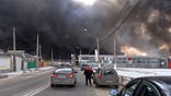Black smoke rises into the sky from the Barabashovo market - one of the largest markets in the eastern Europe covering an area of more than 75 hectares -  which was reportedly hit by shelling, in Kharkiv on March 17, 2022, amid the ongoing Russia's invasion of Ukraine.