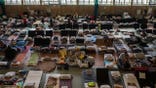FILE - People who fled the war in Ukraine rest inside an indoor sports stadium being used as a refugee center, in the village of Medyka, a border crossing between Poland and Ukraine, on March 15, 2022. The U.N. refugee agency says more than 4 million refugees have now fled Ukraine following Russia’s invasion, a new milestone in the largest refugee crisis in Europe since World War II. (AP Photo/Petros Giannakouris)