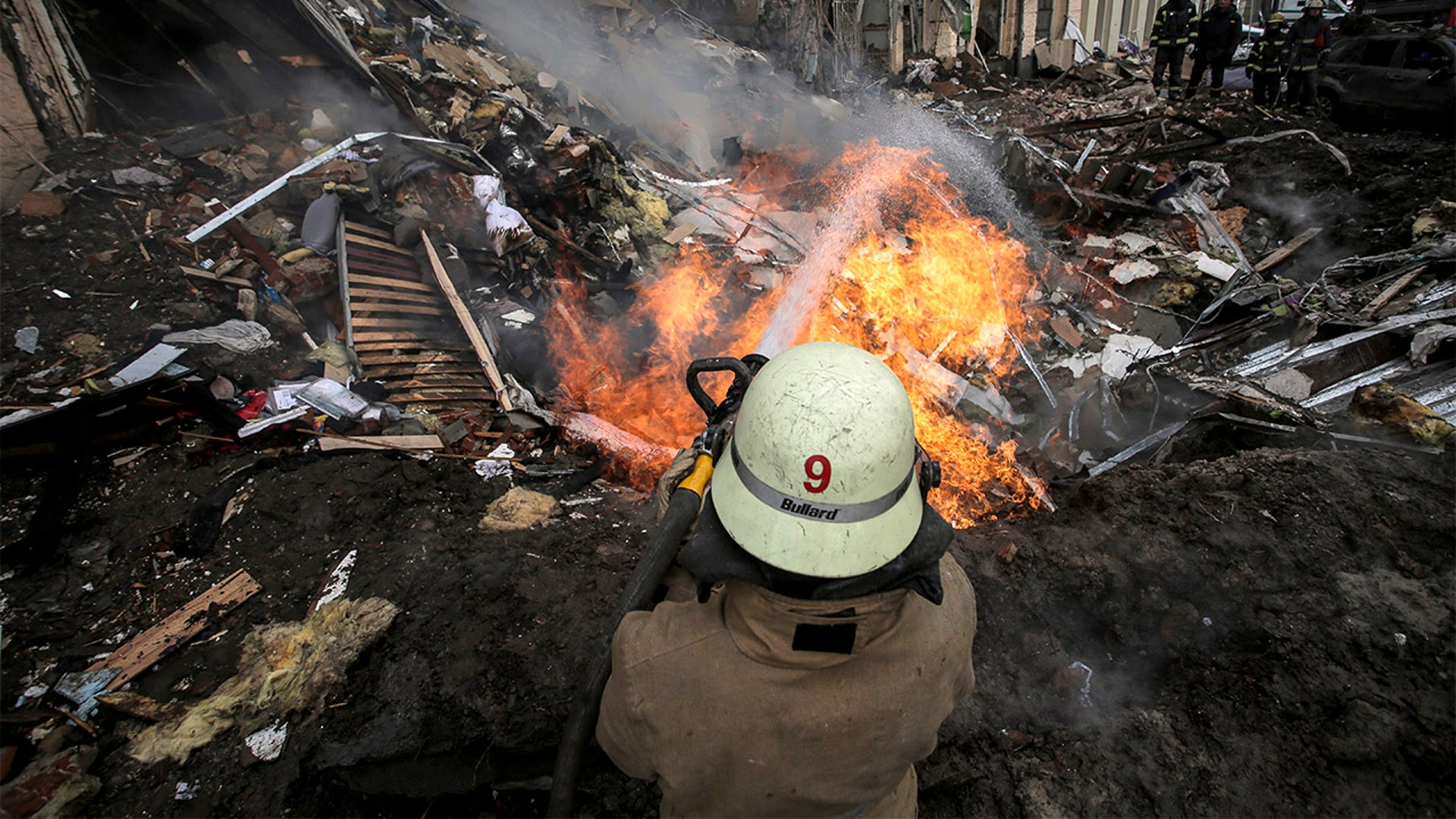 Firefighters extinguish an apartment house after a Russian rocket attack in Kharkiv, Ukraine's second-largest city, Ukraine, Monday, March 14, 2022.