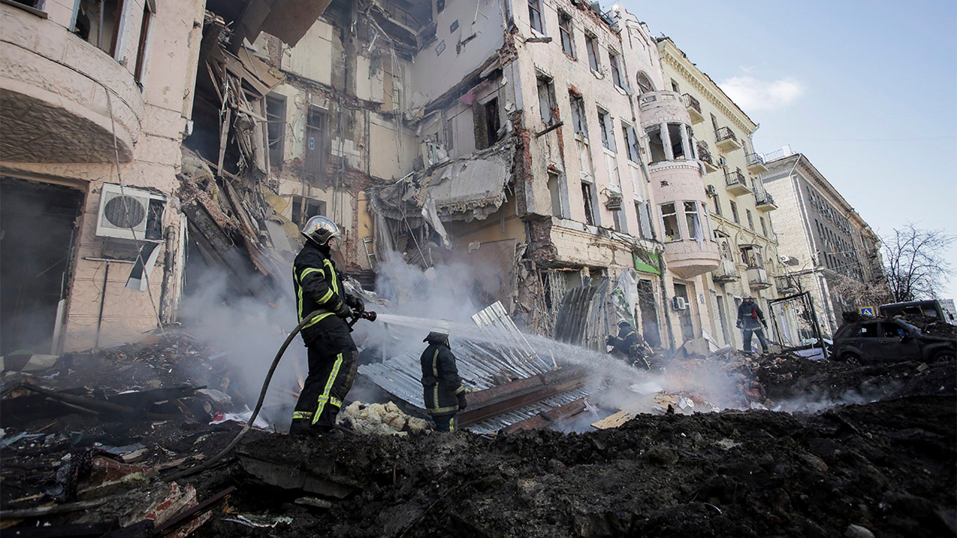 Firefighters extinguish an apartment house after a Russian rocket attack in Kharkiv, Ukraine's second-largest city, Ukraine, Monday, March 14, 2022.