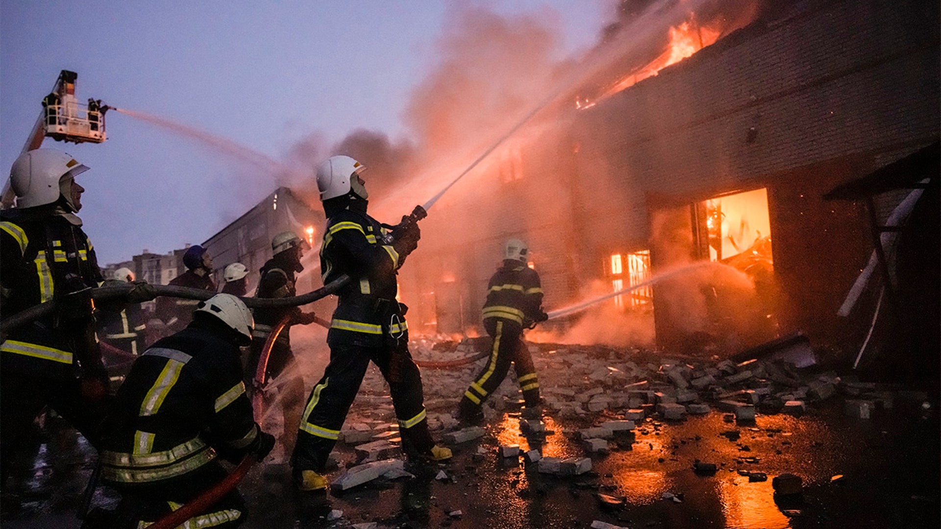 Ukrainian firefighters extinguish a blaze at a warehouse after a bombing in Kyiv, Ukraine, Thursday, March 17, 2022.