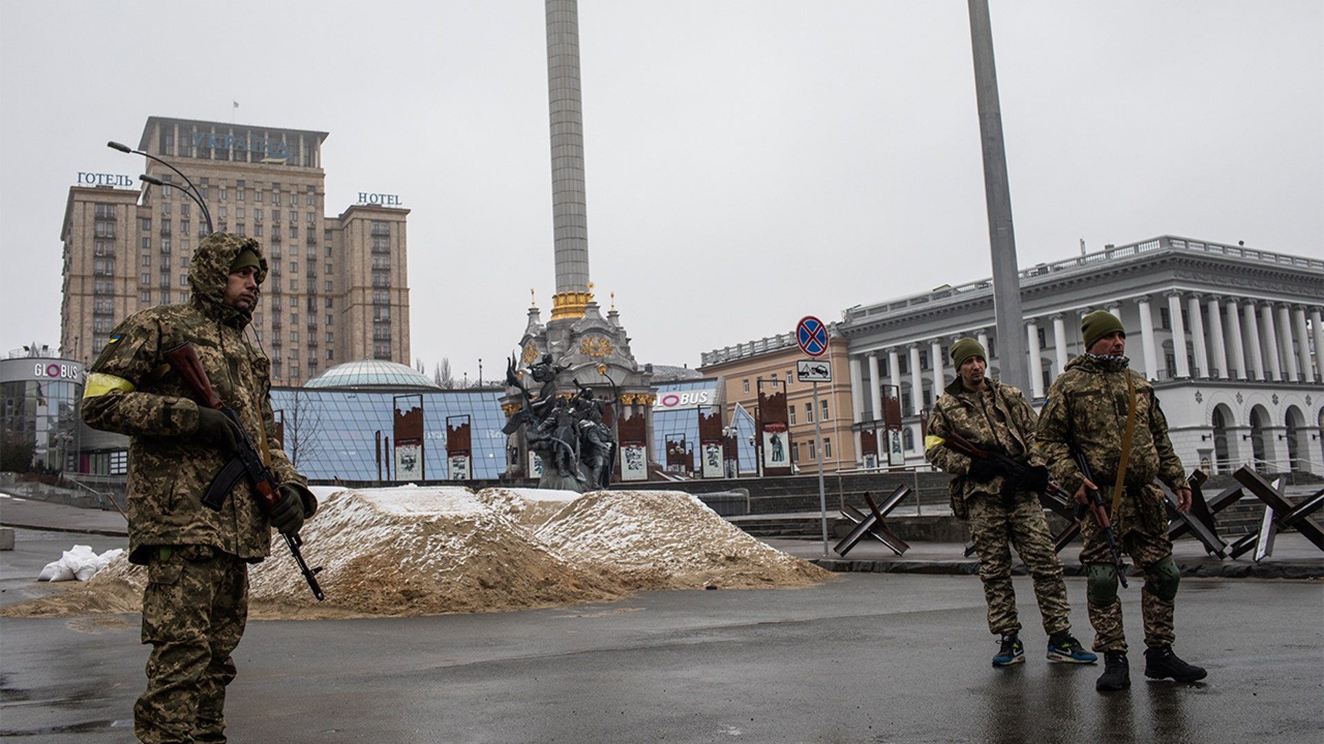 Members of Ukraine's Territorial Defense stand guard next to sand berms at Independence Square in Kyiv, Ukraine, on Wednesday, March 2, 2022.