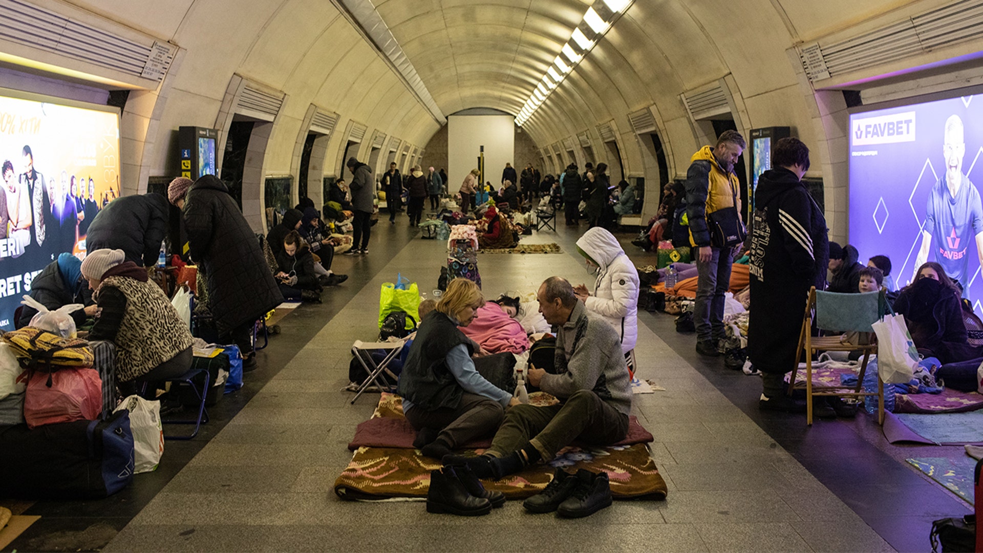 Residents take shelter in the lower level of a Kyiv metro station during Russian artillery strikes in Kyiv, Ukraine, on Wednesday, March 2, 2022.