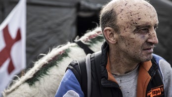 Russia-Ukraine war: Photos show Ukrainians traversing broken bridges to flee as those at home bury their dead