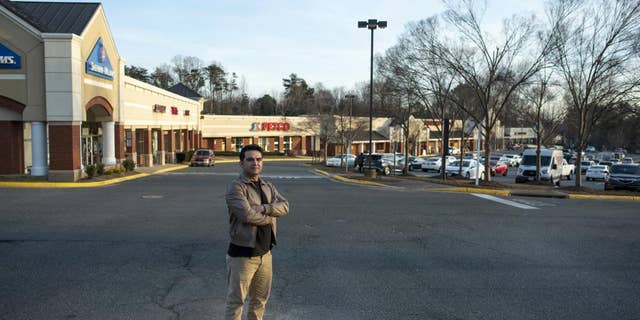 Afghan refugee Ahmad Saeed Totakhail poses for a photograph at a shopping center near his home in Dale City, Va., Wednesday, Feb. 16, 2022.