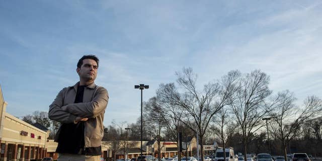 Afghan refugee Ahmad Saeed Totakhail poses for a photograph at a shopping center near his home in Dale City, Va.