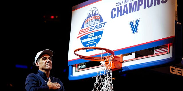 Villanova head coach Jay Wright gestures to supporters while cutting down the net after the final of the Big East conference tournament against Creighton, Saturday, March 12, 2022, in New York.