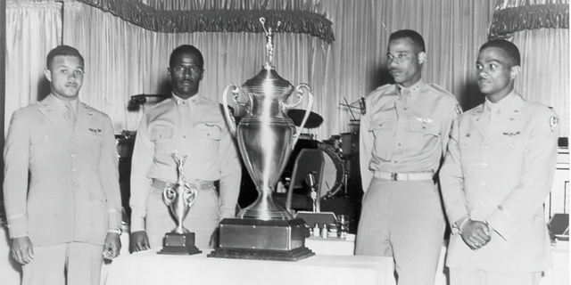 Lt. Col. James H. Harvey III, Capt. Alva Temple, 1st Lt. Harry Stewart Jr. and alternate member 1st Lt. Halbert Alexander pose with the first-ever ‘Top Gun’ trophy, which they earned during the 1949 USAF Fighter Gunnery Meet at Las Vegas Air Force Base.