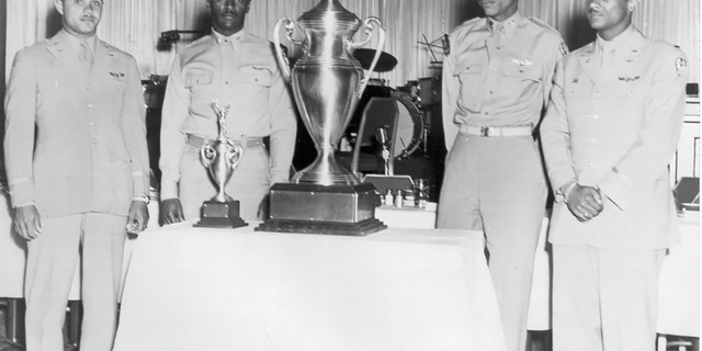 Lt. Col. James H. Harvey III, Capt. Alva Temple, 1st Lt. Harry Stewart Jr. and alternate member 1st Lt. Halbert Alexander pose with the first-ever ‘Top Gun’ trophy, which they earned during the 1949 USAF Fighter Gunnery Meet at Las Vegas Air Force Base.