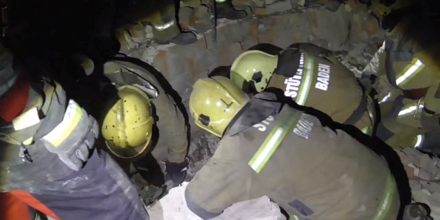 Rescue crews dig through the rubble looking for survivors after strikes by Russian forces amid their invasion, in Sumy, Ukraine March 7, 2022 in this handout video still image obtained March 8, 2022.
