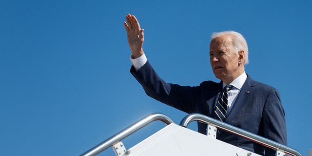 U.S. President Joe Biden waves as he boards Air Force One for travel to Philadelphia from Joint Base Andrews, Maryland, U.S. March 11, 2022. 