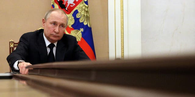 Russian President Vladimir Putin attends a meeting with government members via a video link in Moscow March 10, 2022.