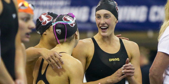 Stanford Cardinal swimmer Taylor Ruck celebrates with teammates after winning the 800 free relay national championship at the NCAA women’s swimming and diving championships at Georgia Tech.