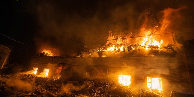 Rescuers work at a site of buildings damaged by a shelling, as Russia's attack on Ukraine continues, in Kyiv, Ukraine, in this handout picture released March 17, 2022.