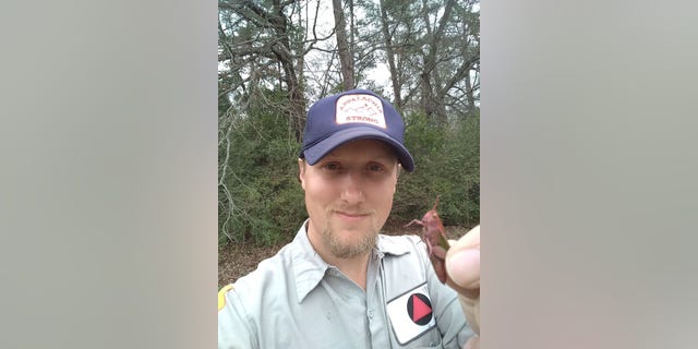 Dirk Parker showed off the pink grasshopper he found during a walk in Texas.