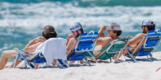FILE – March 26, 2022: Spring breakers at Panama City Beach.