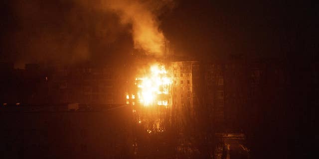 A fire burns at an apartment building after it was hit by shelling in Mariupol, Ukraine, March 11, 2022.