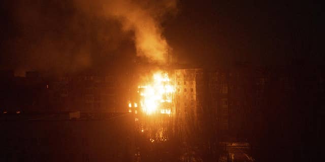 A fire burns at an apartment building after it was hit by shelling in Mariupol, Ukraine, March 11, 2022.