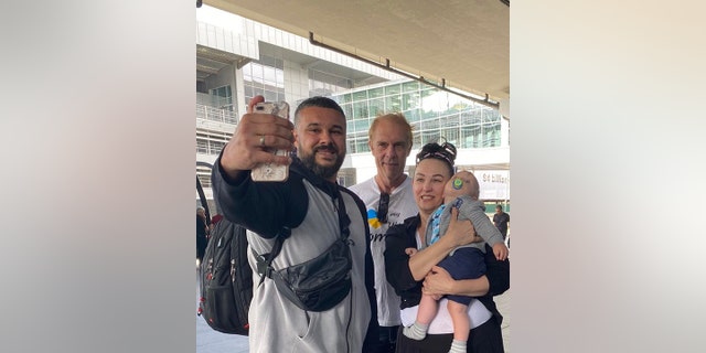 Irena Laura Yoder of Iowa is shown in Ukraine (at right) with her son TJ, grandson Mark (in her arms) and boyfriend Steven in September 2021.