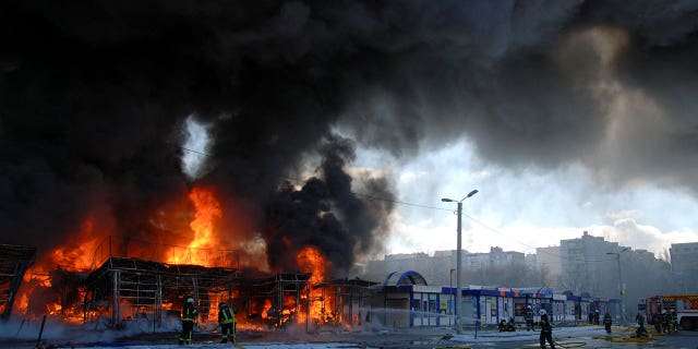 Firefighters work at a site of a fire, as Russia's invasion of Ukraine continues, in Kharkiv, Ukraine March 16, 2022.