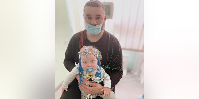 Irena Laura Yoder's little grandson Mark, age 1, shown above, has neurological issues, which require medical attention. Baby Mark is seen in this undated photo with his father, TJ, Yoder's son.
