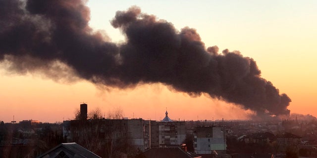 A cloud of smoke rises after an explosion in Lviv, western Ukraine, Friday, March 18, 2022. The mayor of Lviv says missiles struck near the city's airport early Friday. 