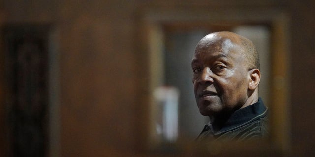 Rev. David Bigsby poses for a photo at his church in Lansing, Ill., 