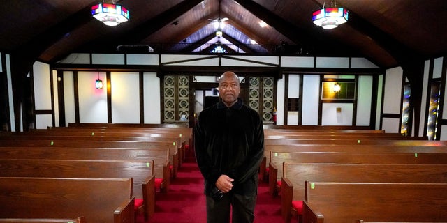 Rev. David Bigsby poses for a photo at his church in Lansing, Ill.