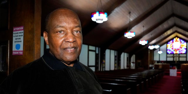 Rev. David Bigsby poses for a photo at his church in Lansing, Ill.