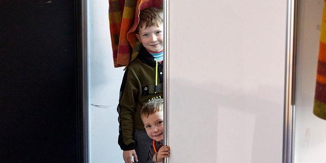 Children from Ukraine smile at a facility for refugees in Chisinau, Moldova, Monday, Feb. 28, 2022. 